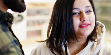 Indian couple performs transactions from the bank atm.