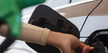 view-woman-with-car-gas-station_430